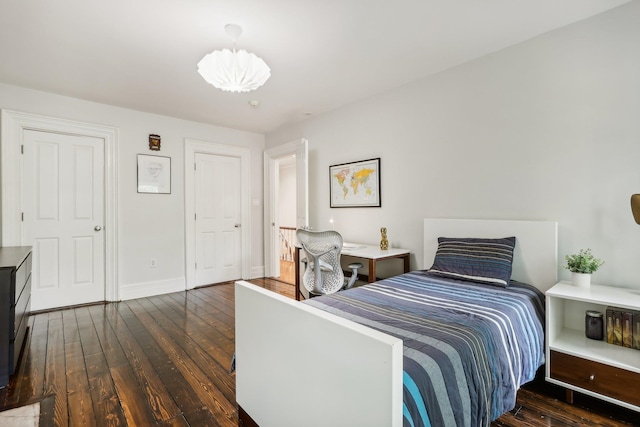 bedroom with dark wood-type flooring