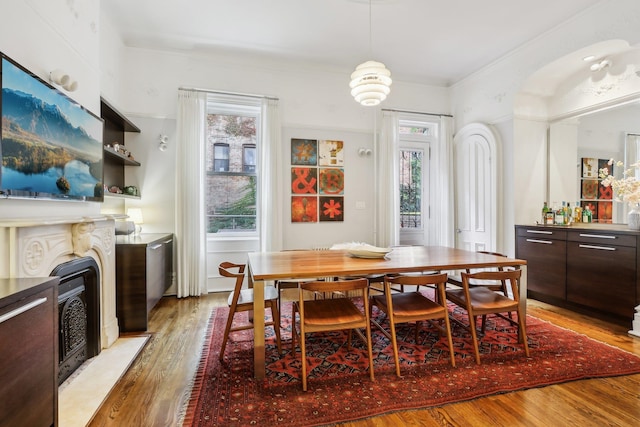 dining area with crown molding and light hardwood / wood-style flooring