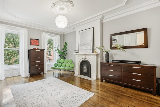 living area with dark wood-type flooring and crown molding