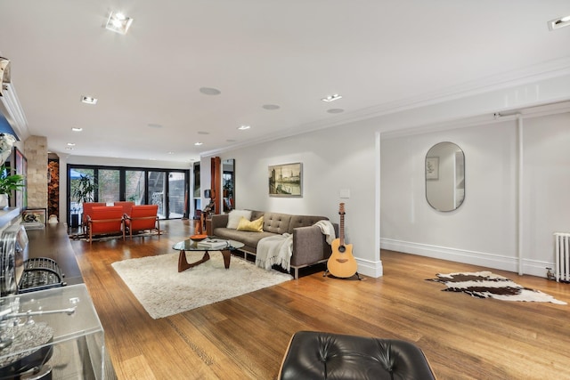 living room with hardwood / wood-style floors and ornamental molding