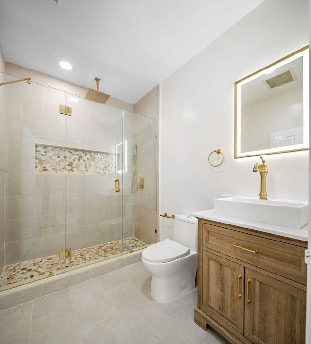 bathroom with visible vents, a stall shower, vanity, tile patterned floors, and toilet