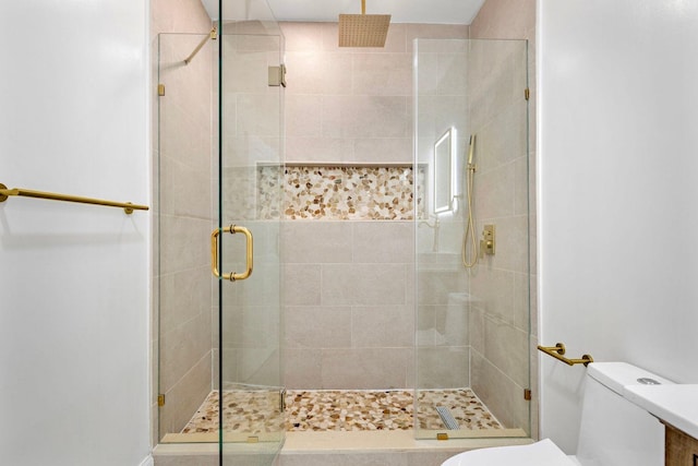 full bath featuring toilet and a shower stall