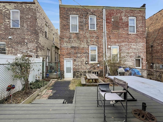 back of house featuring a wooden deck