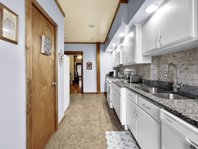 kitchen with white appliances, sink, decorative backsplash, and white cabinets