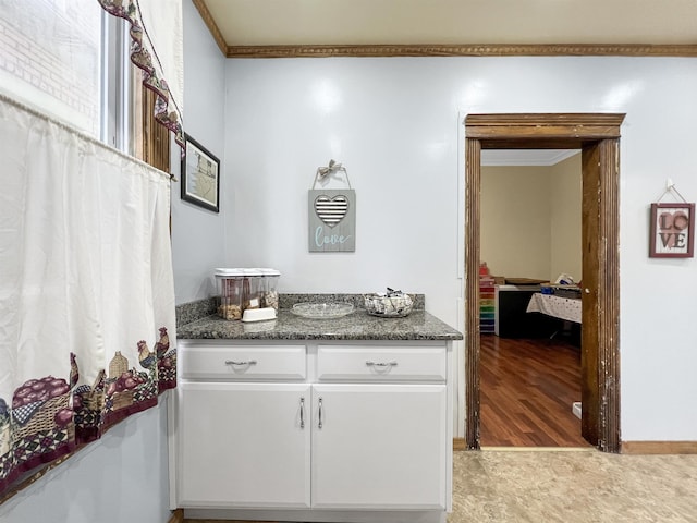 bathroom with ornamental molding, hardwood / wood-style floors, and vanity