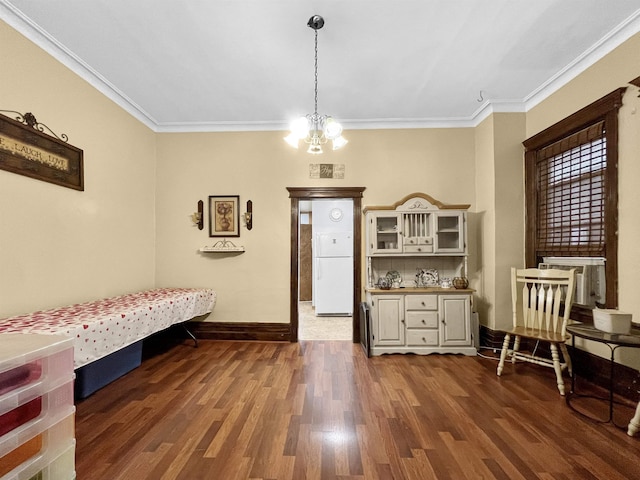 sitting room featuring an inviting chandelier, dark wood-type flooring, and ornamental molding