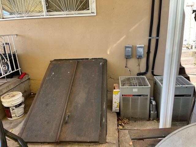 view of storm shelter with central AC unit