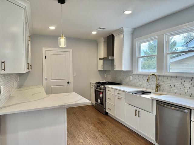 3 Raydol Ave, Secaucus, NJ 07094 - kitchen featuring appliances with stainless steel finishes, wall chimney range hood, white cabinetry, backsplash, and recessed lighting