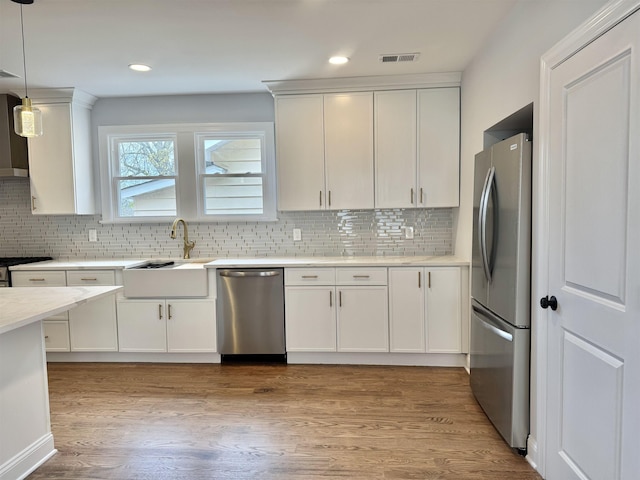 3 Raydol Ave, Secaucus, NJ 07094 - kitchen with stainless steel appliances, tasteful backsplash, light countertops, white cabinetry, and recessed lighting