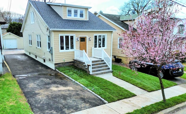 3 Raydol Ave, Secaucus, NJ 07094 - bungalow featuring driveway, a shingled roof, an outdoor structure, a garage, and a front yard