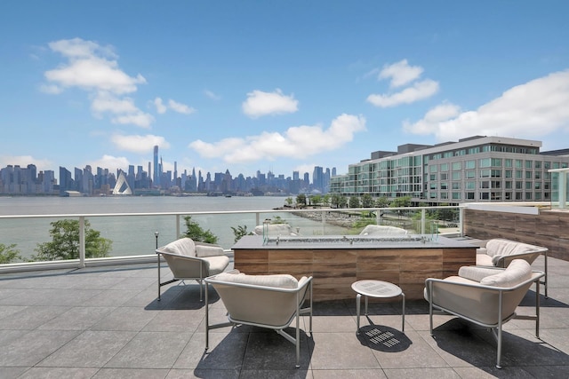 view of patio with a balcony and a water view