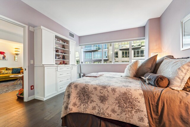 bedroom with dark hardwood / wood-style floors