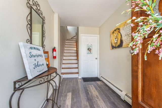 foyer entrance with stairs, dark wood-type flooring, and baseboard heating