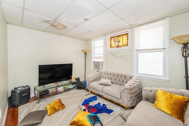 living area featuring cooling unit and a drop ceiling