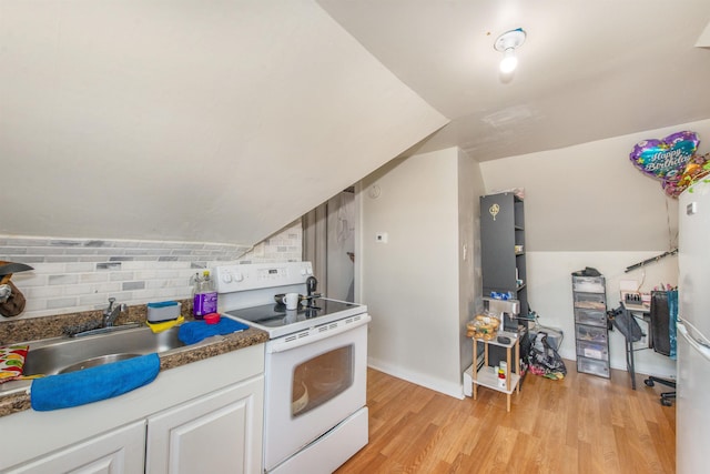 kitchen with decorative backsplash, vaulted ceiling, white cabinets, electric stove, and light wood-style floors