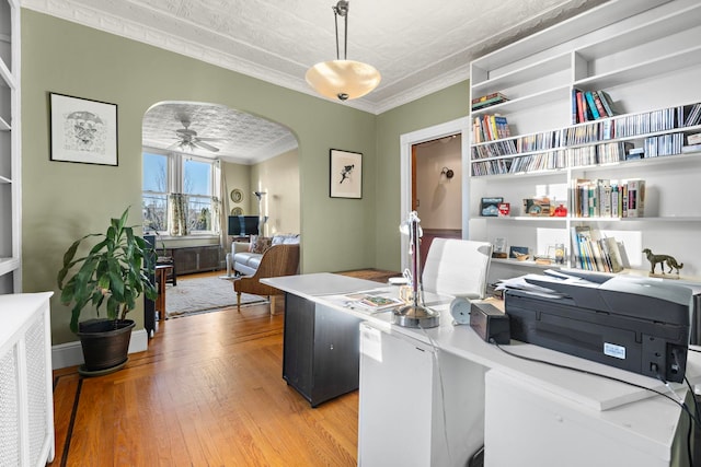 office area with light wood-type flooring, ceiling fan, ornamental molding, and a textured ceiling