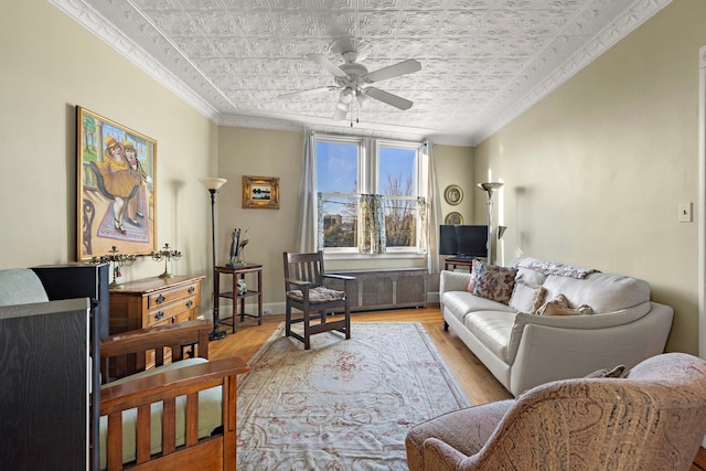 living room with ceiling fan, light hardwood / wood-style flooring, and crown molding