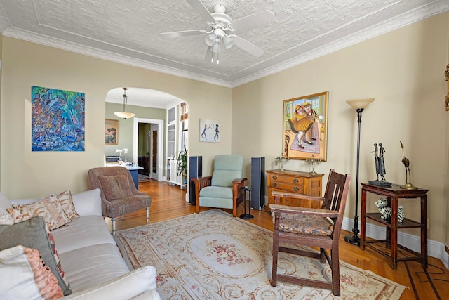 living room featuring ceiling fan, light hardwood / wood-style floors, and ornamental molding