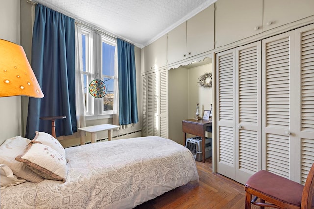 bedroom with a textured ceiling, dark parquet floors, and crown molding