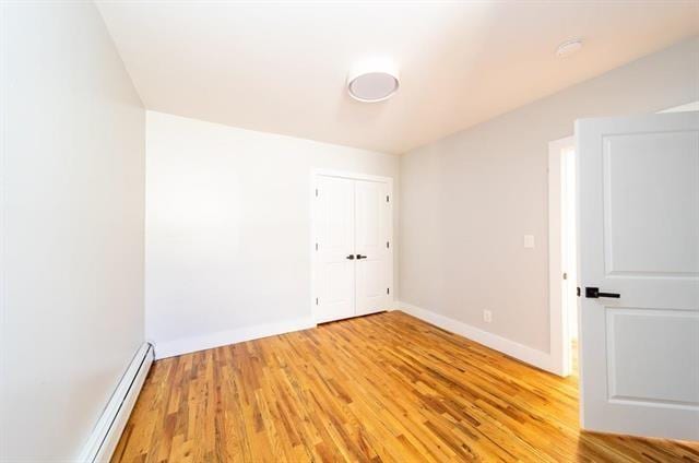 481 Martin Luther King Jr Dr, Jersey City, NJ 07304 - empty room featuring light wood-style flooring, baseboards, and baseboard heating