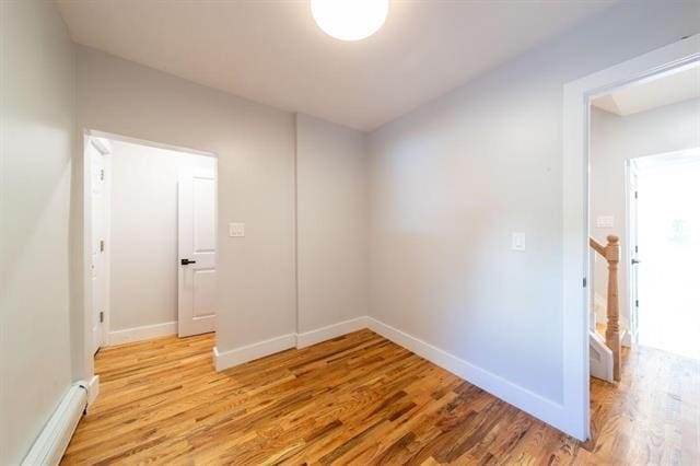 481 Martin Luther King Jr Dr, Jersey City, NJ 07304 - unfurnished room with a baseboard heating unit, light wood finished floors, and baseboards