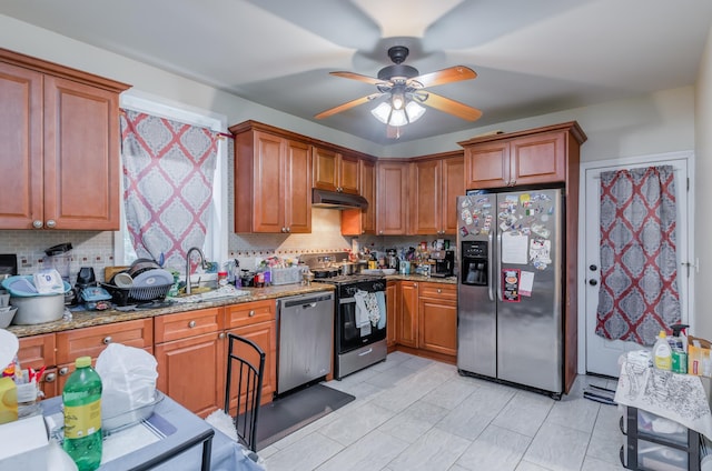27 W 4th St, Bayonne, NJ 07002 - kitchen with stainless steel appliances, light stone countertops, decorative backsplash, and brown cabinets