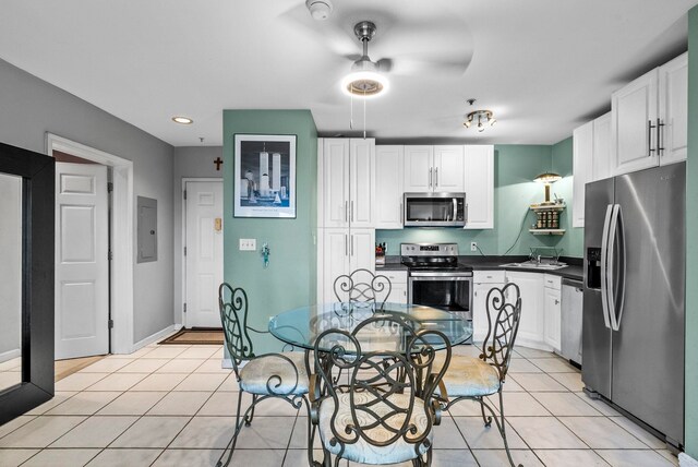 8915 Bergenwood Ave Unit 37, North Bergen, NJ 07047 - kitchen featuring appliances with stainless steel finishes, white cabinets, light tile patterned flooring, dark countertops, and recessed lighting