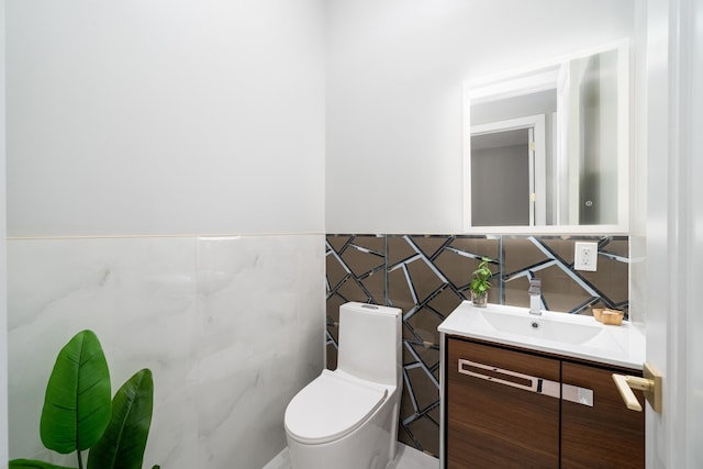 bathroom featuring tile walls, toilet, and vanity