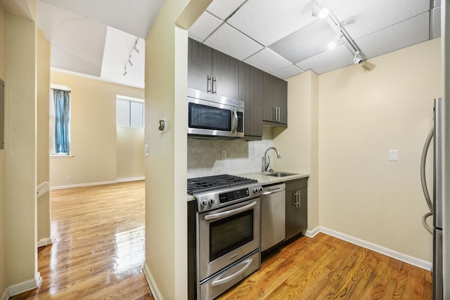 341 Monmouth St Unit 104D, Jersey City, NJ 07302 - kitchen featuring appliances with stainless steel finishes, rail lighting, and light wood-style flooring