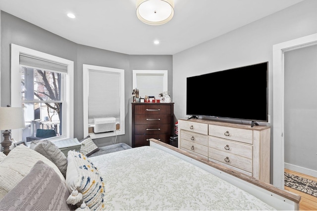 bedroom featuring wood-type flooring and cooling unit