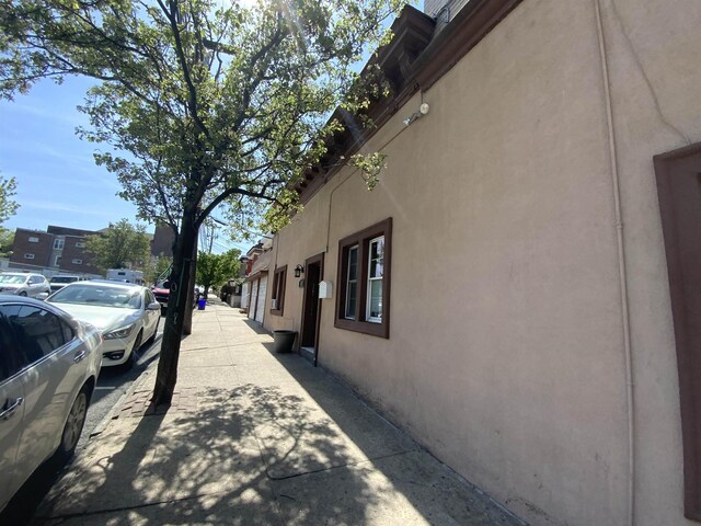 143 64th St, West New York, NJ 07093 - view of home's exterior featuring stucco siding