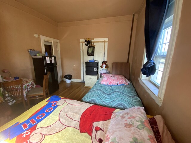 143 64th St, West New York, NJ 07093 - bedroom with freestanding refrigerator and wood finished floors