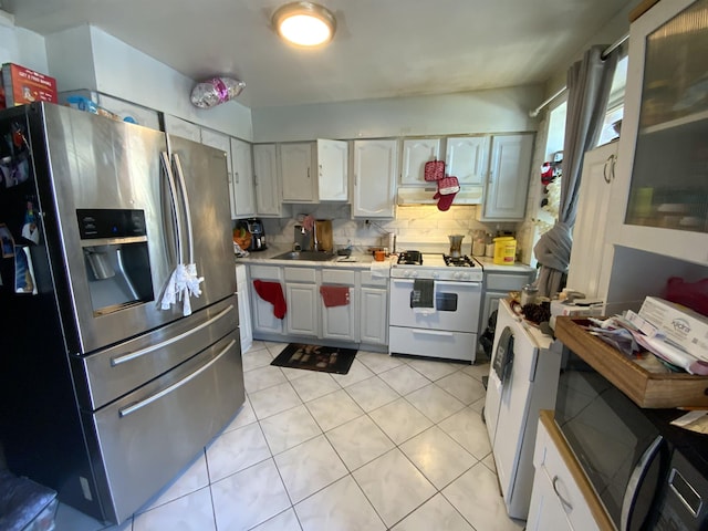 143 64th St, West New York, NJ 07093 - kitchen with stainless steel fridge with ice dispenser, white range with gas stovetop, light countertops, backsplash, and light tile patterned floors
