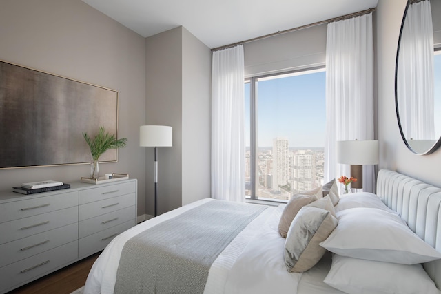 99 Hudson St Unit 4903, Jersey City, NJ 07302 - bedroom featuring radiator, a view of city, and dark wood finished floors