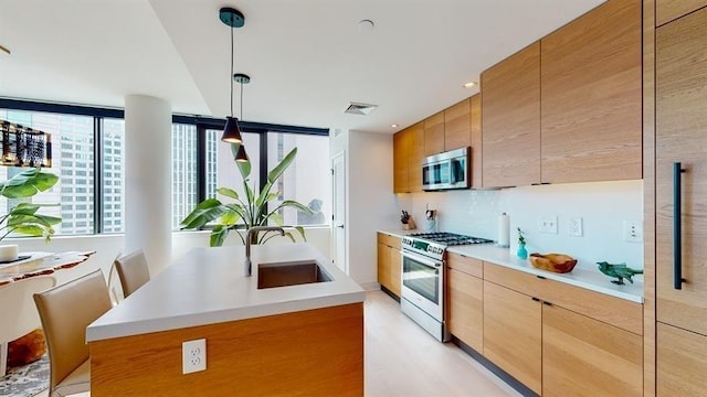 10 Provost St Unit 1004, Jersey City, NJ 07302 - kitchen with appliances with stainless steel finishes, a sink, light countertops, a center island with sink, and recessed lighting