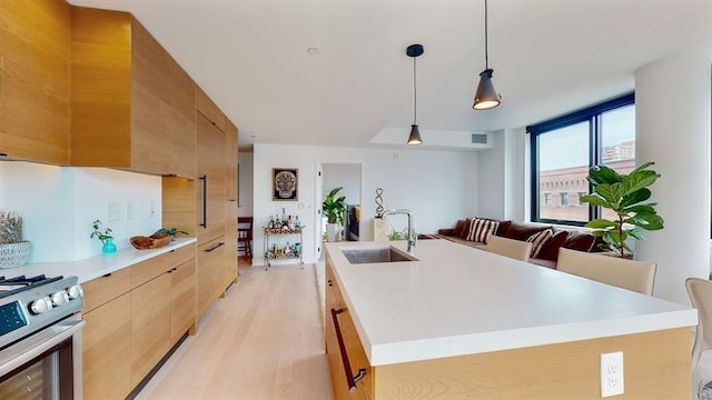 10 Provost St Unit 1004, Jersey City, NJ 07302 - kitchen featuring a sink, modern cabinets, gas stove, light wood-style floors, and light countertops