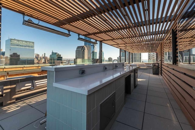 10 Provost St Unit 1004, Jersey City, NJ 07302 - view of patio / terrace with a view of skyline and an outdoor kitchen
