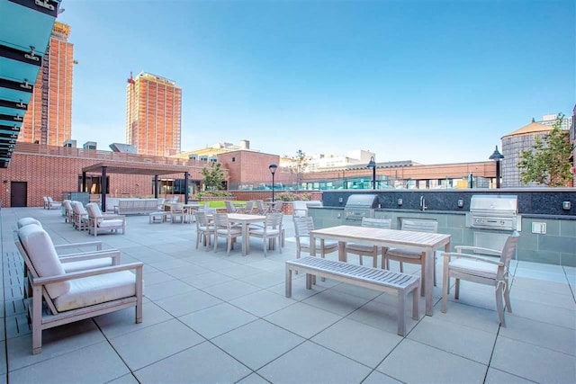 10 Provost St Unit 1004, Jersey City, NJ 07302 - view of patio / terrace featuring outdoor dining space, a grill, and an outdoor kitchen