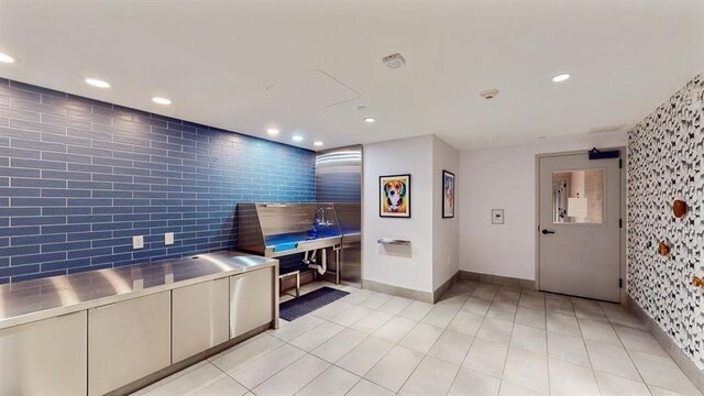 10 Provost St Unit 1004, Jersey City, NJ 07302 - kitchen with stainless steel countertops, recessed lighting, baseboards, an accent wall, and pet washing station