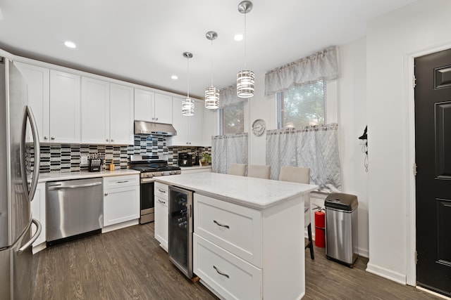 kitchen featuring stainless steel appliances, wine cooler, white cabinets, pendant lighting, and dark hardwood / wood-style flooring