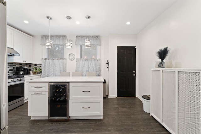 kitchen with white cabinetry, stainless steel range, extractor fan, and wine cooler