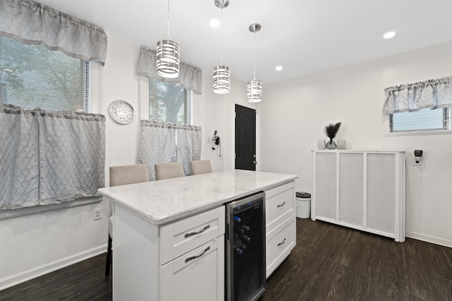 kitchen with white cabinetry, plenty of natural light, hanging light fixtures, and wine cooler