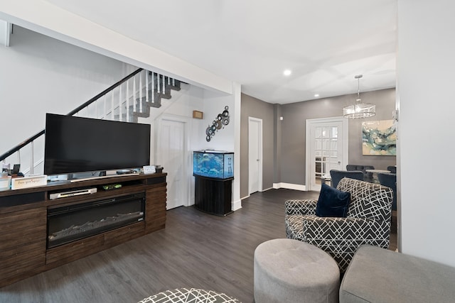 living room with wood-type flooring and a chandelier