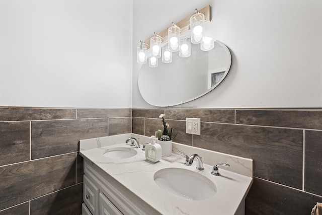 bathroom featuring vanity and tile walls