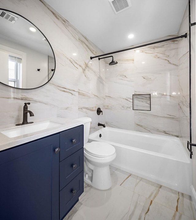 bathroom with tile walls, vanity, shower / bathtub combination, toilet, and marble finish floors