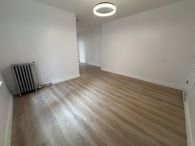 311 79th St Unit 37, North Bergen, NJ 07047 - empty room featuring radiator and wood finished floors