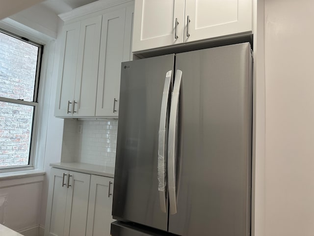 311 79th St Unit 37, North Bergen, NJ 07047 - kitchen featuring freestanding refrigerator, white cabinetry, light countertops, and backsplash