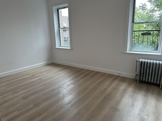 311 79th St Unit 37, North Bergen, NJ 07047 - unfurnished room featuring radiator heating unit and wood finished floors
