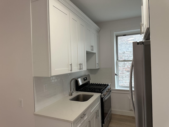 311 79th St Unit 37, North Bergen, NJ 07047 - kitchen with stainless steel appliances, tasteful backsplash, white cabinetry, and light wood-type flooring