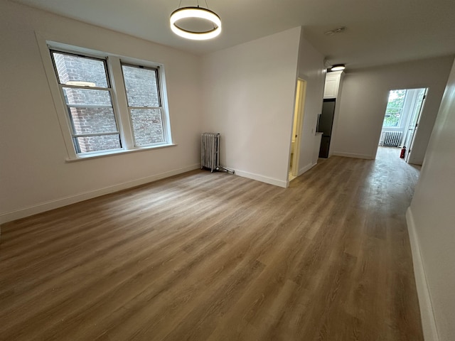 311 79th St Unit 37, North Bergen, NJ 07047 - spare room with radiator and light wood-style flooring